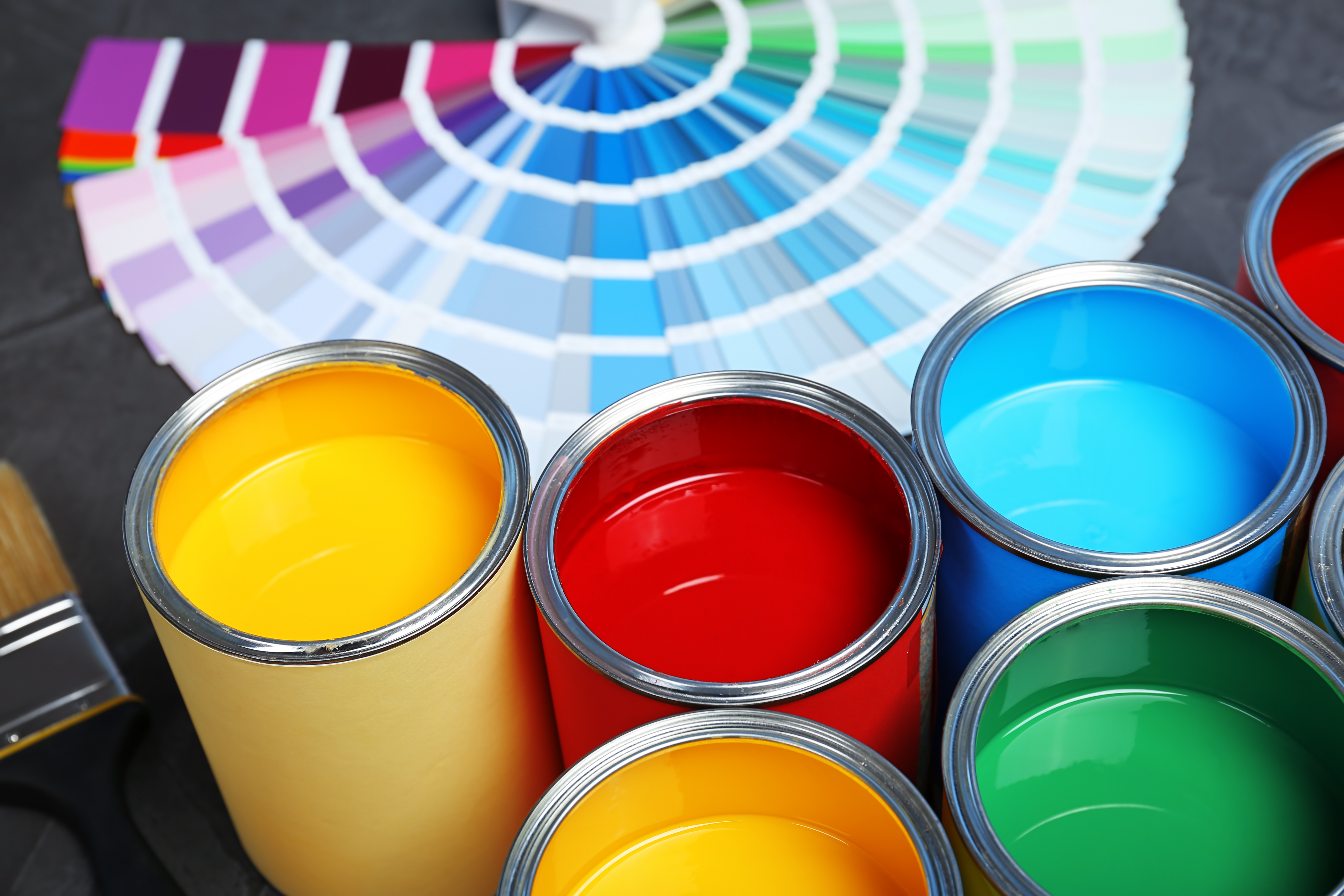 stock-photo-paint-cans-and-color-palette-samples-on-table-closeup-1205751646
